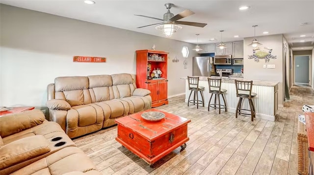 living room with light wood-type flooring and ceiling fan