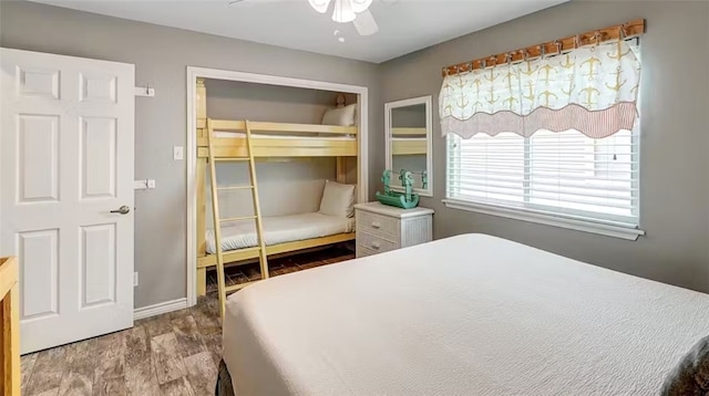 bedroom with a closet, wood-type flooring, and ceiling fan