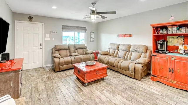 living room featuring ceiling fan and light hardwood / wood-style flooring