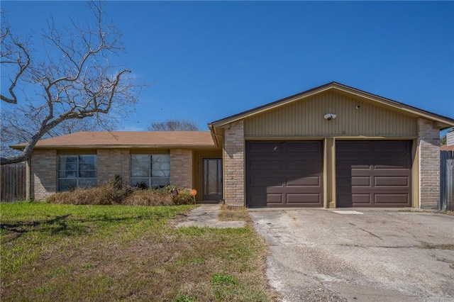 view of front of property with a front lawn, brick siding, driveway, and an attached garage