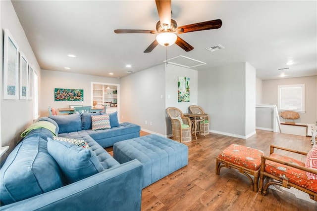 living area with recessed lighting, visible vents, ceiling fan, wood finished floors, and baseboards