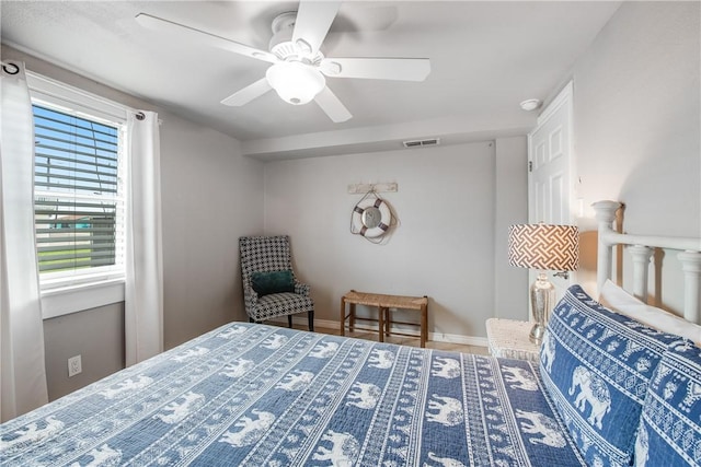 bedroom with baseboards, visible vents, and a ceiling fan