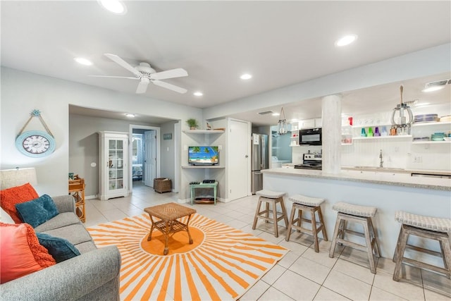 living room featuring light tile patterned floors, a ceiling fan, and recessed lighting