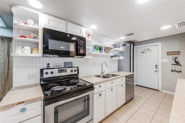 kitchen with a sink, stainless steel appliances, open shelves, and visible vents