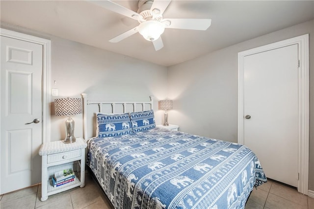 tiled bedroom with ceiling fan