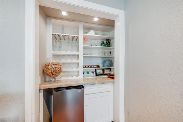 bar featuring built in shelves, recessed lighting, a bar, and fridge