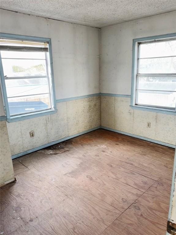 unfurnished room with a textured ceiling