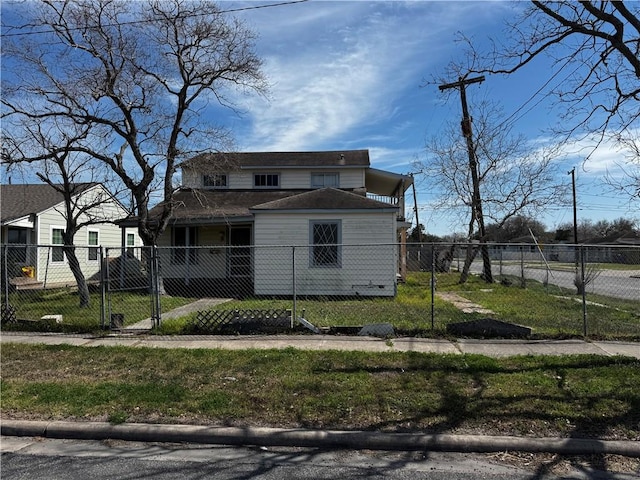 view of front of house featuring a fenced front yard, a front yard, and a gate