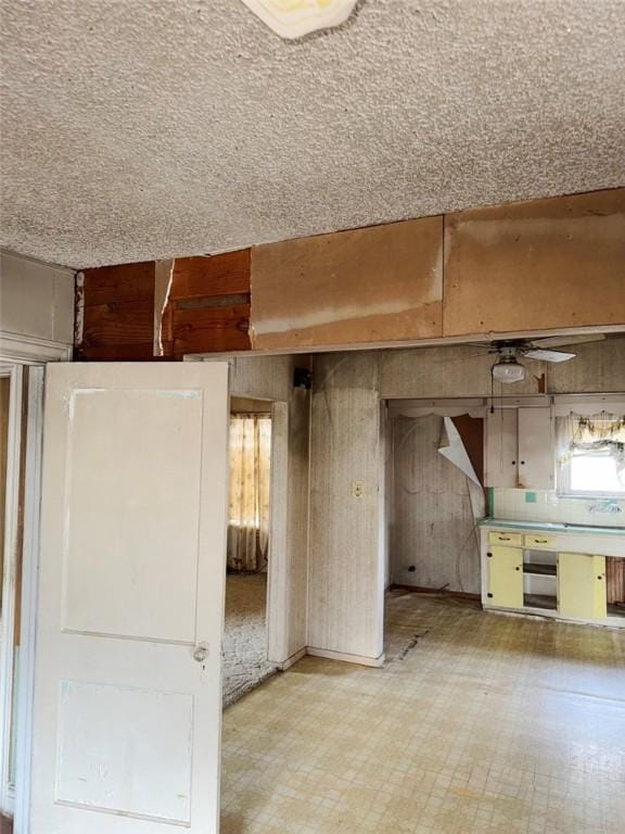 interior space with light floors and wood walls