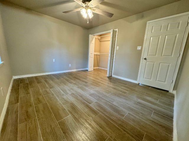 1501 Rose Dr, Alice, TX 78332 - unfurnished bedroom featuring wood finished floors, ceiling fan, and a closet