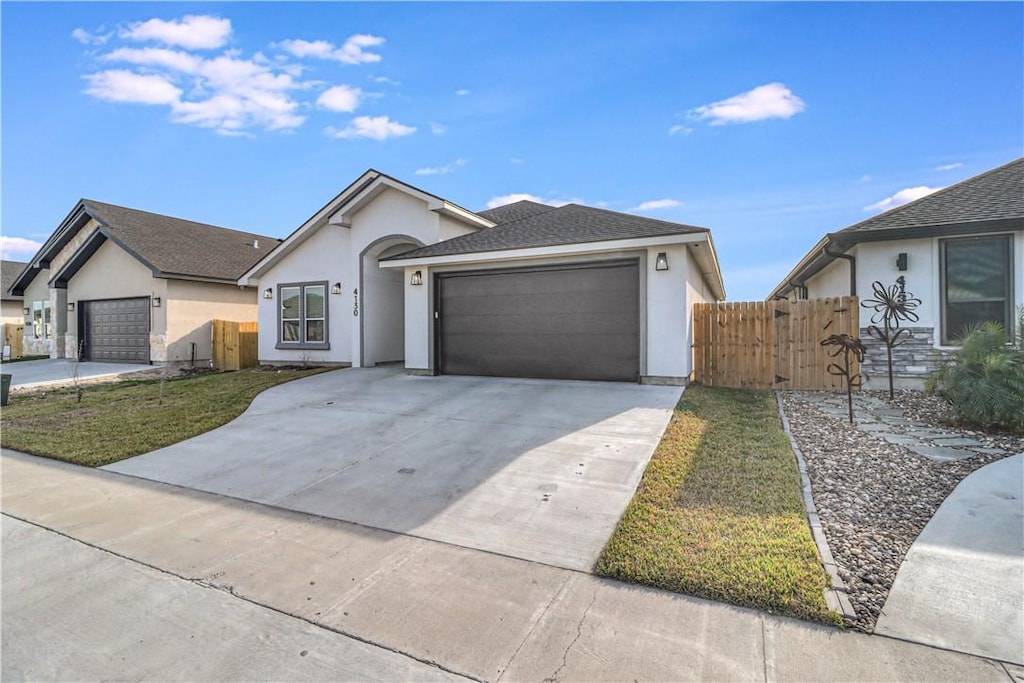 ranch-style house with a garage and a front lawn