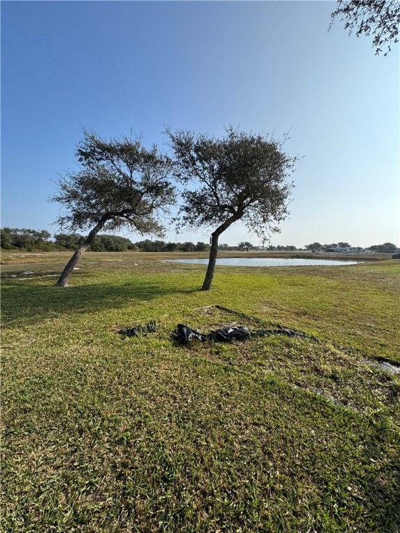 11 Augusta Cir, Aransas Pass, TX 78336 - view of green lawn featuring a water view