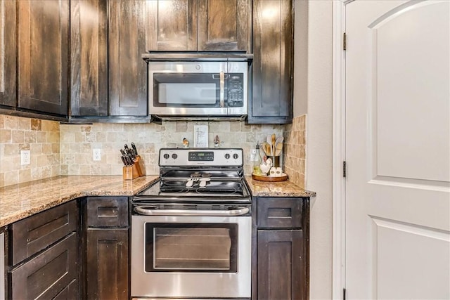 7237 Lake Tranquility Dr, Corpus Christi, TX 78414 - kitchen with light stone counters, tasteful backsplash, dark brown cabinets, and stainless steel appliances