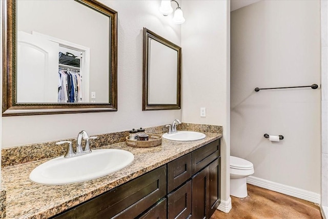 7237 Lake Tranquility Dr, Corpus Christi, TX 78414 - full bathroom with double vanity, toilet, baseboards, and a sink