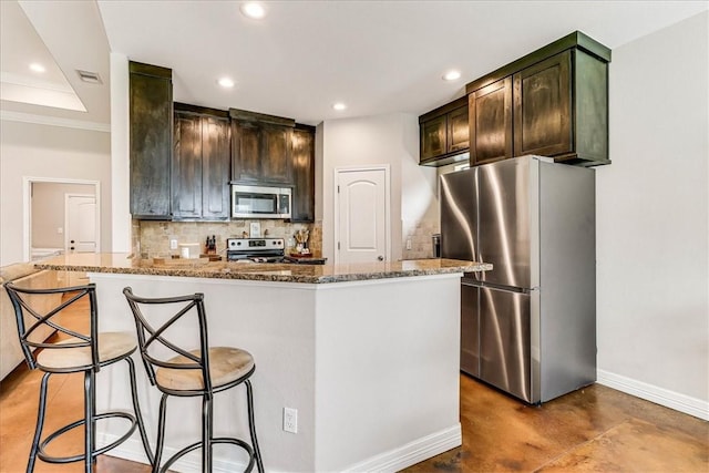 7237 Lake Tranquility Dr, Corpus Christi, TX 78414 - kitchen featuring decorative backsplash, concrete flooring, stone counters, appliances with stainless steel finishes, and recessed lighting