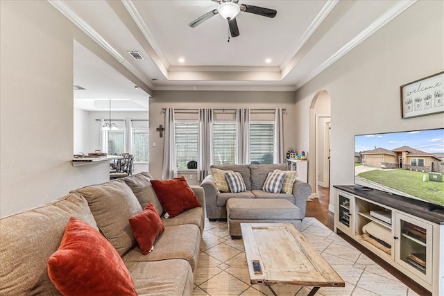 7237 Lake Tranquility Dr, Corpus Christi, TX 78414 - living area featuring a tray ceiling, arched walkways, visible vents, ceiling fan, and ornamental molding