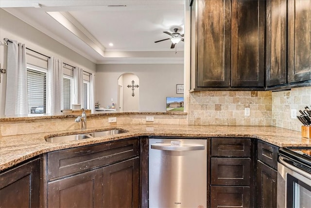 7237 Lake Tranquility Dr, Corpus Christi, TX 78414 - kitchen with stainless steel appliances, arched walkways, a sink, dark brown cabinets, and ceiling fan