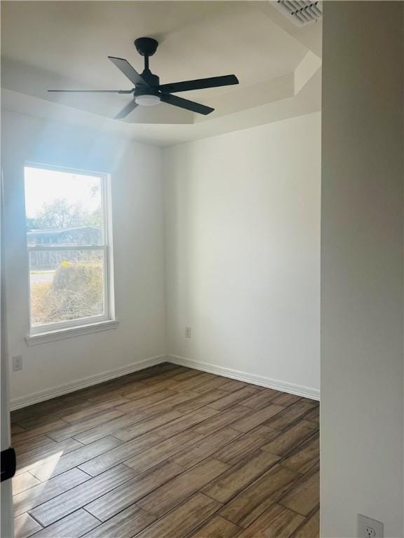 empty room featuring ceiling fan and dark hardwood / wood-style flooring