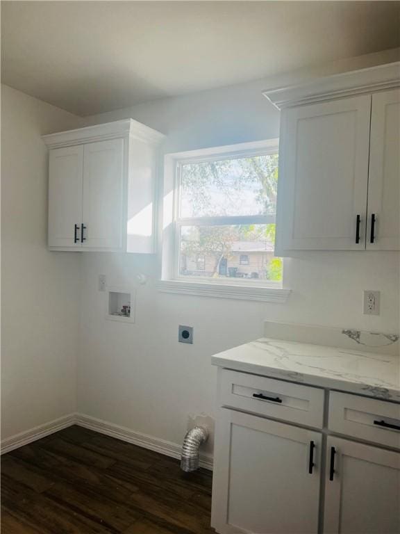 clothes washing area with washer hookup, electric dryer hookup, dark hardwood / wood-style floors, and cabinets