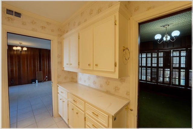 kitchen featuring light tile patterned flooring, a chandelier, and pendant lighting