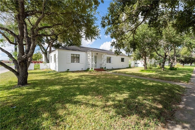 ranch-style home featuring a front yard