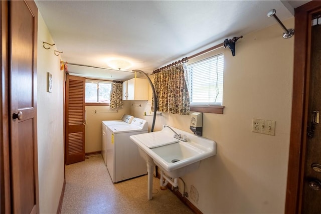 laundry area featuring cabinets, sink, and washing machine and clothes dryer