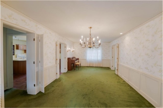 unfurnished dining area with dark colored carpet, ornamental molding, and a notable chandelier