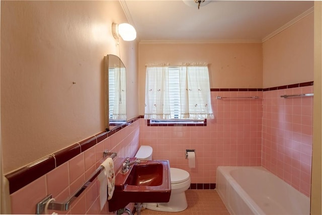 bathroom with toilet, sink, crown molding, tile walls, and a bath