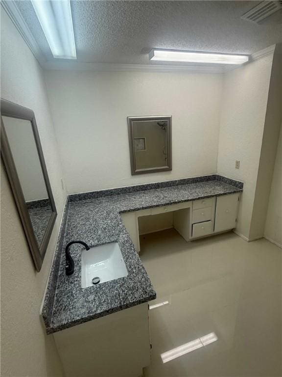 bathroom with visible vents, a textured ceiling, and vanity