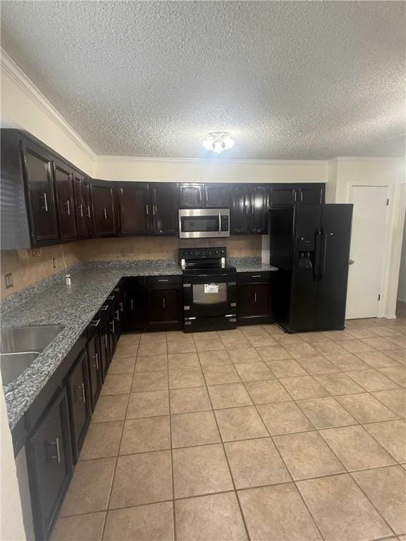 kitchen featuring black appliances, light tile patterned floors, dark stone counters, and a sink