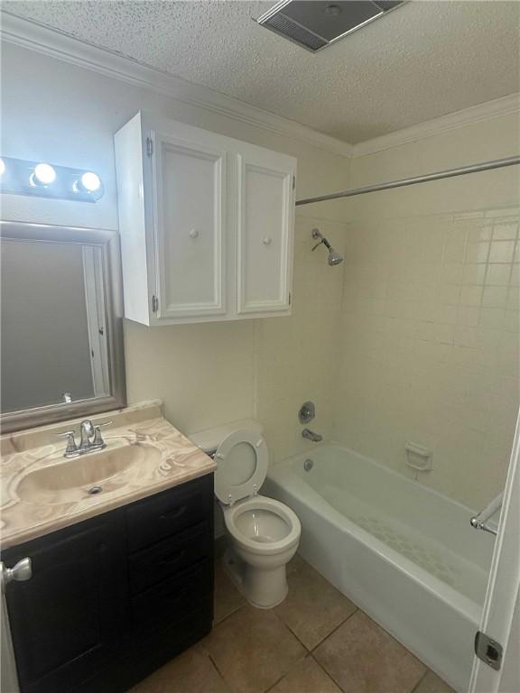 full bath with tile patterned flooring, shower / bathing tub combination, a textured ceiling, and vanity