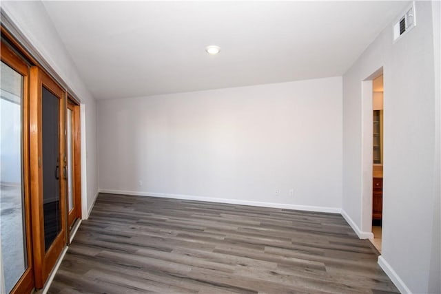 spare room with dark wood-type flooring