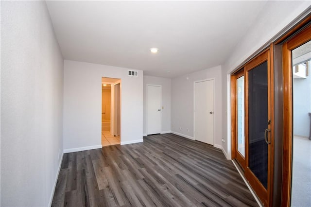 spare room featuring dark wood-type flooring