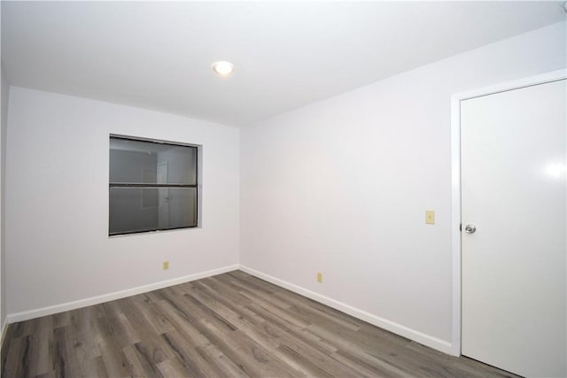 spare room featuring dark wood-type flooring