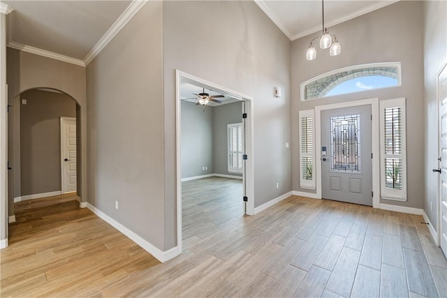 14150 Coquina Bay Ave, Corpus Christi, TX 78418 - foyer entrance with light wood finished floors, a ceiling fan, baseboards, arched walkways, and ornamental molding