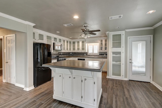 kitchen with stainless steel appliances, a sink, and white cabinetry