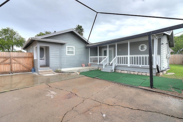 view of front facade featuring fence and a porch