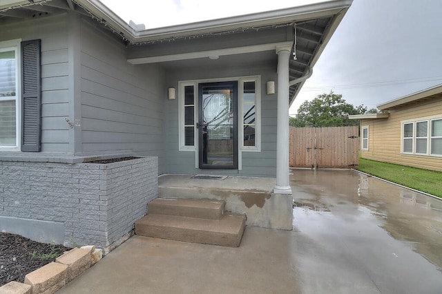 view of exterior entry featuring brick siding