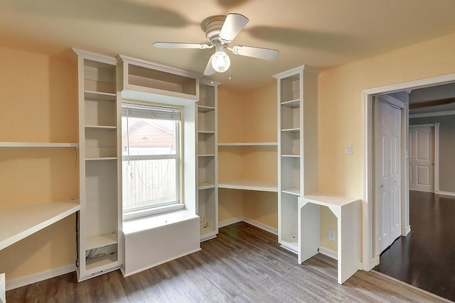 unfurnished office featuring baseboards, a ceiling fan, and wood finished floors