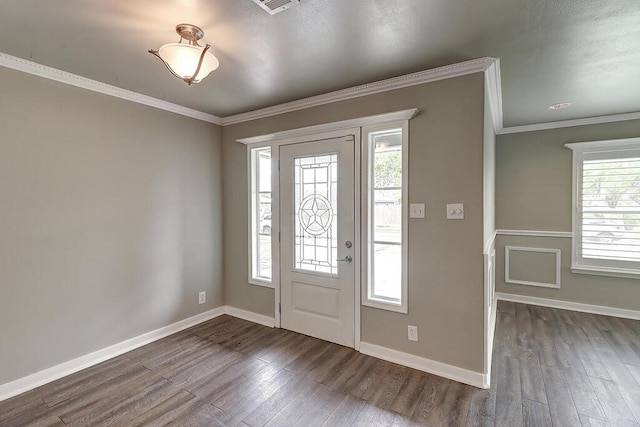 foyer with baseboards, dark wood-style flooring, and crown molding