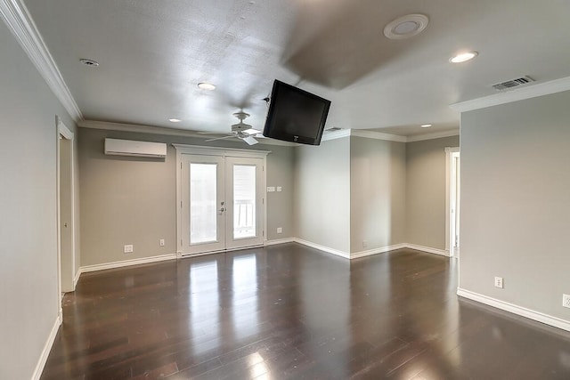 spare room with baseboards, visible vents, wood finished floors, an AC wall unit, and french doors