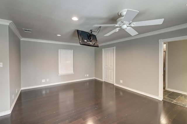 unfurnished room featuring baseboards, visible vents, wood finished floors, and ornamental molding