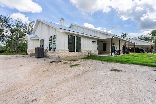 view of front of property with a front lawn and central air condition unit