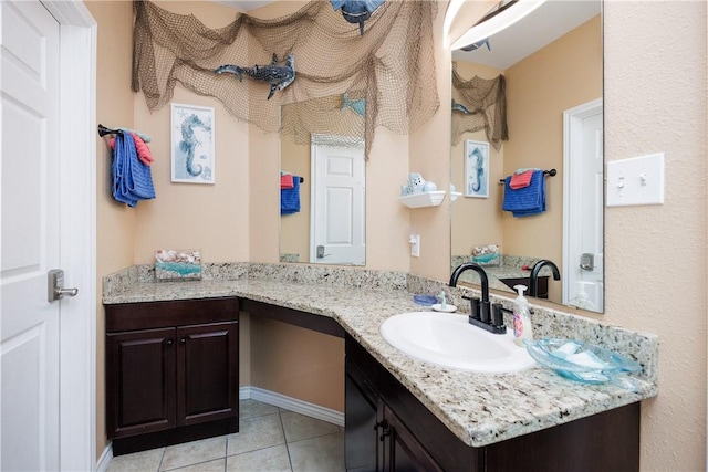 bathroom with tile patterned flooring and vanity