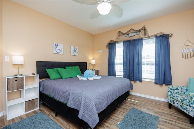 bedroom featuring hardwood / wood-style flooring and ceiling fan