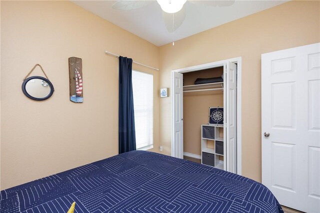 unfurnished bedroom featuring multiple windows, ceiling fan, and a closet