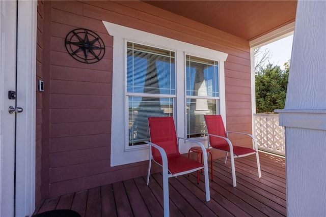 wooden terrace featuring covered porch