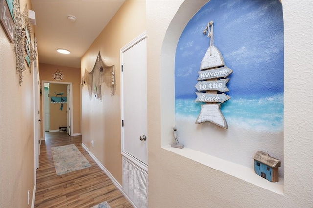 112 Tropical Breeze Ln, Aransas Pass, TX 78336 - corridor featuring wood finished floors, arched walkways, and recessed lighting