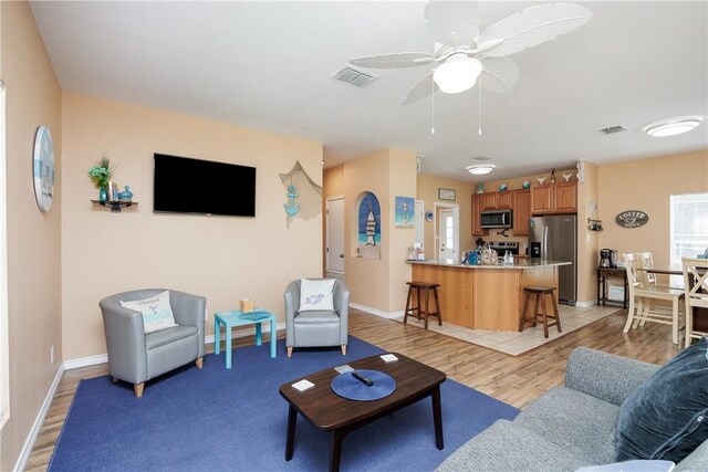 112 Tropical Breeze Ln, Aransas Pass, TX 78336 - living room with light wood-style flooring and ceiling fan