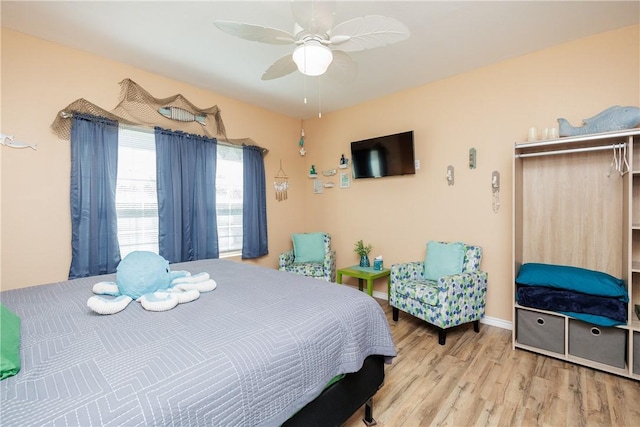 bedroom with light wood-type flooring and ceiling fan